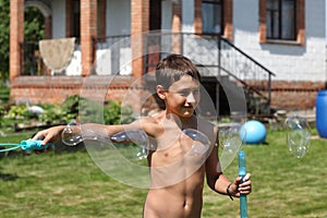 Boy making soap bubbles