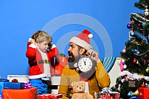 Boy and man with beard and excited faces celebrate Christmas.