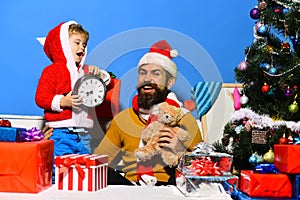 Boy and man with beard and happy faces celebrate Christmas