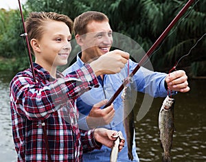 Boy and man fishing