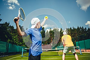 Boy and man playing tennis