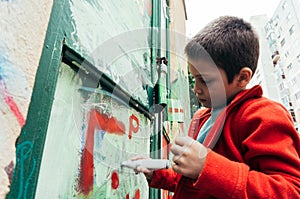 Boy with marker drawing graffiti