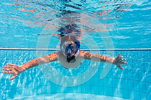 Boy in mask dive in swimming pool