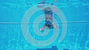 Boy in mask dive in swimming pool