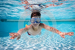 Boy in mask dive in swimming pool