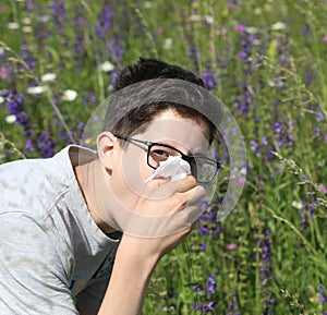 Boy in the meadows with allergy in spring