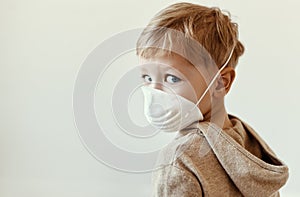 Boy in medical mask looking over shoulder