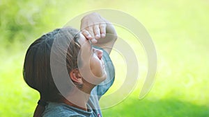 Boy meditates thinks outdoors.