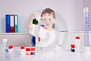 Boy mixing colored liquids in test tubes