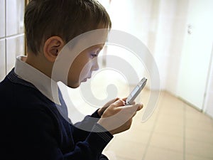 Boy with mobile phone sitting in policlinic