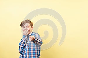 Boy mocking and laughing pointing finger at viewer photo