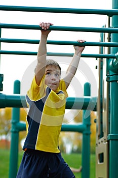 Boy on Monkey Bars photo