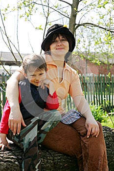 Boy with mother embracing in nature. tender sentiment