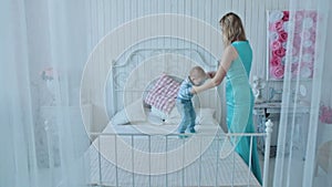 Boy with mother jumping on bed