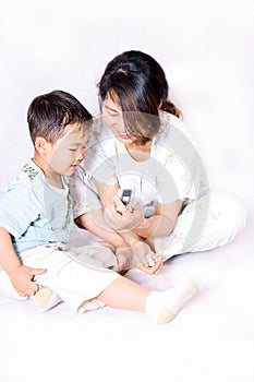 Boy and mother looking at cell phone