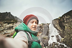 Boy mountain hiker invite somebody walk with him to waterfall