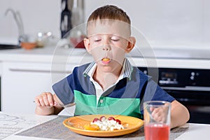 Boy with Mouth Full Eating Cheese and Fruit