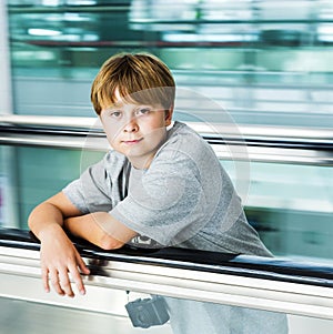 Boy on moving staircase
