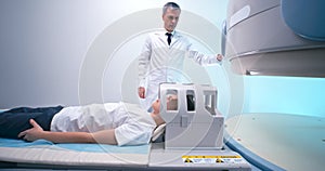 Boy during MRI procedure with mature doctor