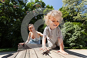 Boy and mum playing with bubbles