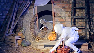 A boy mummy collects candies in a basket