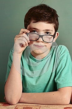 Boy in myopia glasses close up photo