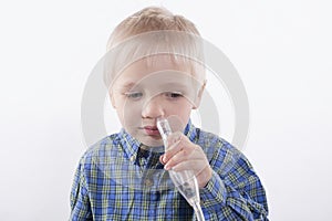 Boy and nasal aspirator