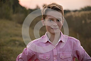 Boy in nature, looking at the camera