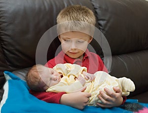 Boy and newborn sibling