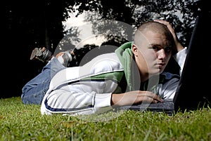 Boy with notebook in park