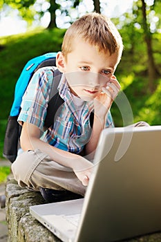 Boy with notebook in the park