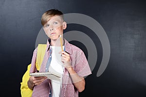 Boy with notebook and pen