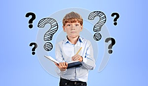 Boy with notebook and question marks