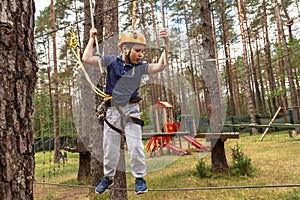 A boy on an obstacle in a rope town