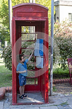 boy in old and old telephone booth