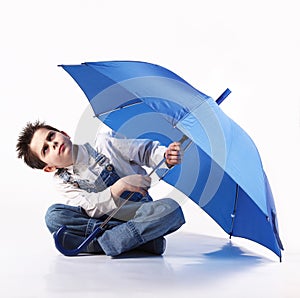 Boy with an open umbrella looking up