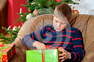 Boy is opening his christmas presents