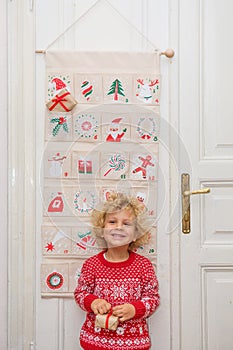 The boy opens a gift from the advent calendar