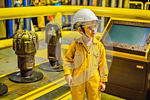 Boy operator recording operation of oil and gas process at oil and rig plant, offshore oil and gas industry, offshore