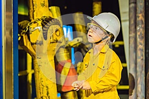 Boy operator recording operation of oil and gas process at oil and rig plant, offshore oil and gas industry, offshore