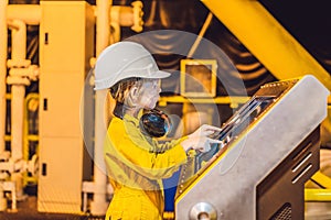 Boy operator recording operation of oil and gas process at oil and rig plant, offshore oil and gas industry, offshore