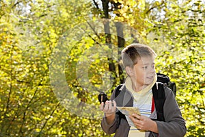 Boy orienteering in forest