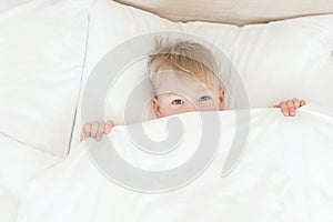 Boy out from under the blanket