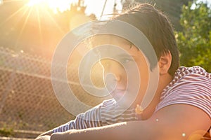 Boy outdoors at sunset