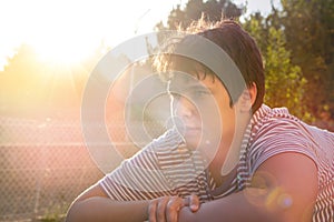 Boy outdoors at sunset