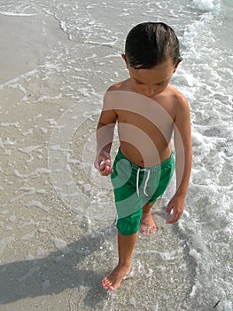 Boy paddling in sea
