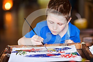 Boy painting a batik