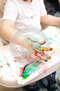 Boy painting with finger-paints