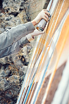 Boy painting graffiti close-up