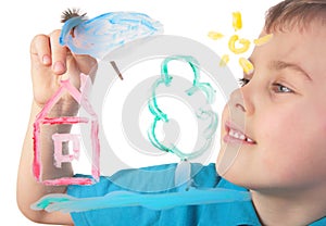 Boy paints on glass cloud and house